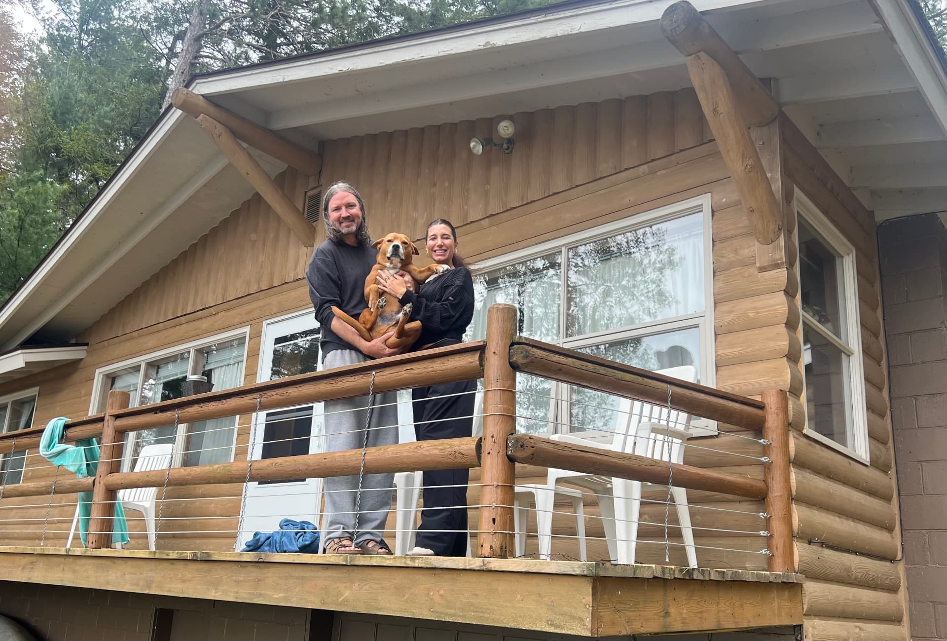 Patrick and Sarah with their dog at the Three Lakes cabin